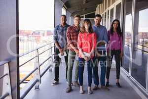 Full length portrait of smiling business people in balcony