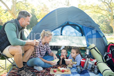 Family having snacks outside the tent