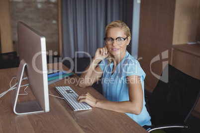 Thoughtful executive sitting at desk