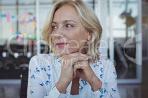 Thoughtful entrepreneur sitting at office