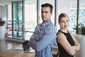 Portrait of executives standing with arms crossed