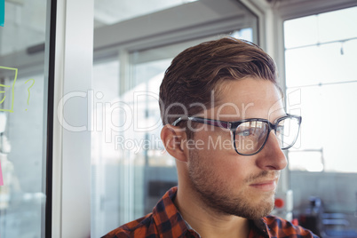 Thoughtful businessman looking away in office
