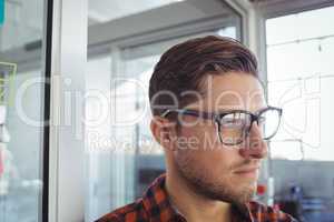 Thoughtful businessman looking away in office