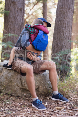 Father embracing son in forest