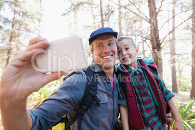 Happy father and son taking selfie from mobile phone