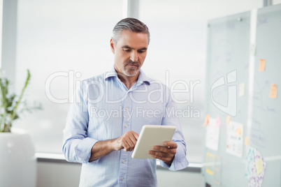 Attentive executive using digital tablet