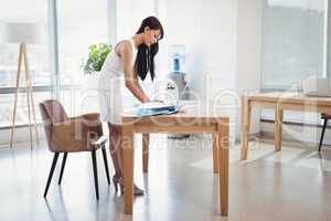 Attentive executive using laptop at desk