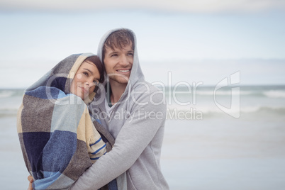 Thoughtful youn couple embracing during winter