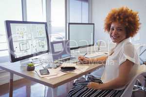Confident businesswoman working in creative office