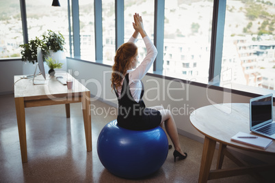 Executive exercising on fitness ball