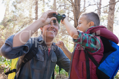 Low angle view of father and son with binoculars