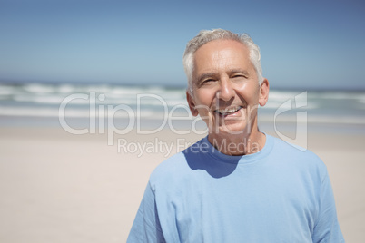 Portrait of smiling senior man at beach