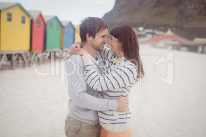 Smiling couple embracing at beach