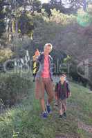 Happy father pointing while hiking with son