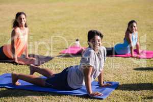 Portrait of children and instructor practicing yoga