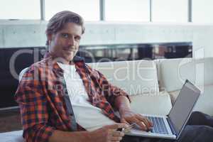 Portrait of entrepreneur shopping online with credit card