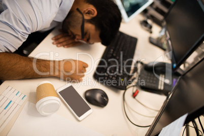 Tired businessman sleeping at desk