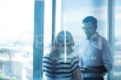 Business couple reading book in office
