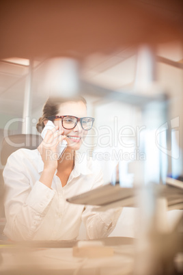 Smiling businesswoman talking on mobile phone