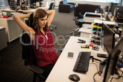 Young businesswoman relaxing at desk in office