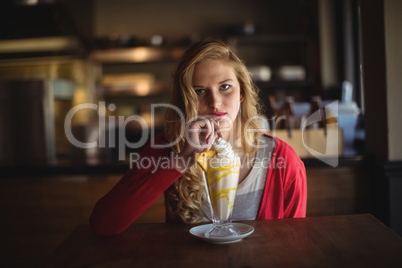 Portrait of beautiful woman having milkshake