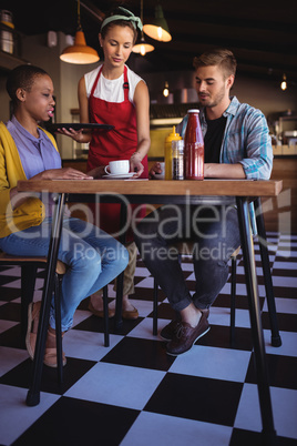 Waitress serving coffee to customer