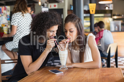 Young couple having drink together in restaurant
