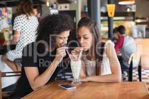 Young couple having drink together in restaurant