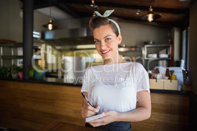 Portrait of smiling waitress in restaurant