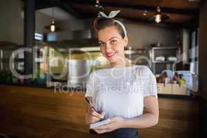 Portrait of smiling waitress in restaurant