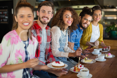 Portrait of friends sitting at restaurant