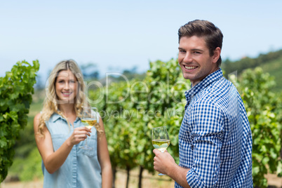 Portrait of smiling young couple holding wineglasses