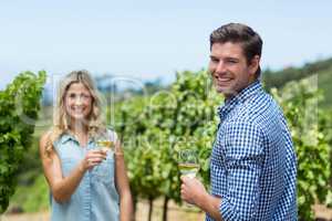 Portrait of smiling young couple holding wineglasses