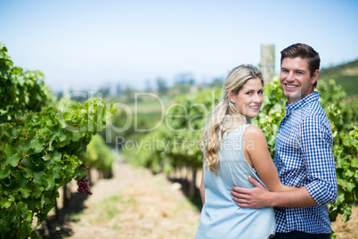 Portrait of couple embracing at vineyard