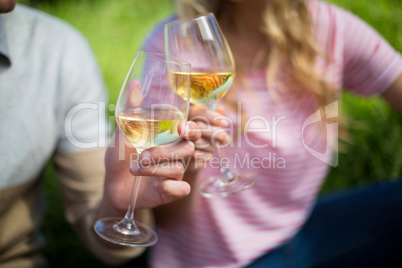 Couple toasting white wine glasses