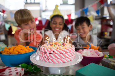 Siblings celebrating birthday in kitchen