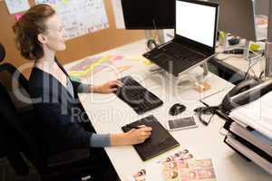 High angle view of photo editor working at desk