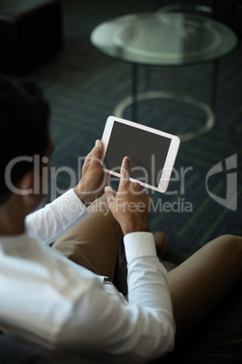 Businessman using digital tablet while at office