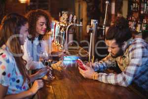 Bartender taking an order on notepad at counter