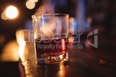 Close-up of whisky glass at counter