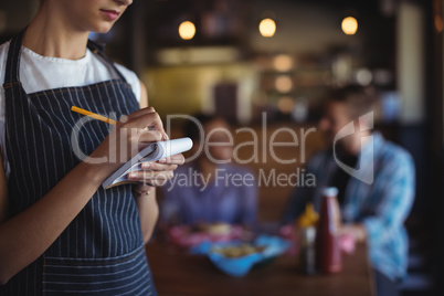 Waitress taking order at restaurant