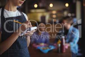 Waitress taking order at restaurant