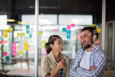 Male and female executive interacting with each other