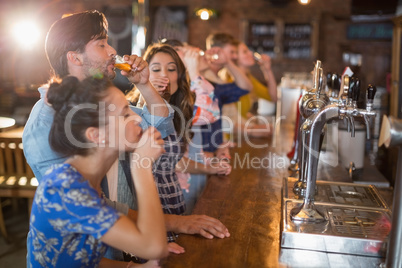Friends drinking vodka shorts in bar
