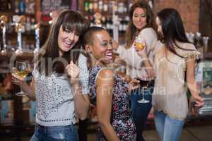 Female friends enjoying at pub