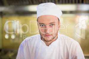 Serious male chef in commercial kitchen
