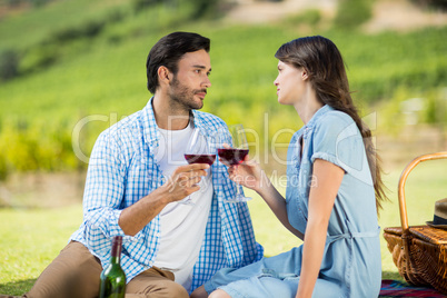 Romantic couple staring at each other while holding wineglasses