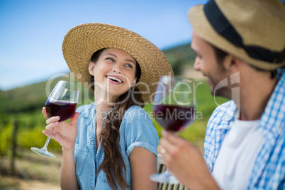 Happy couple holding red wine