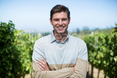 Portrait of smiling man with arms crossed at vineyard