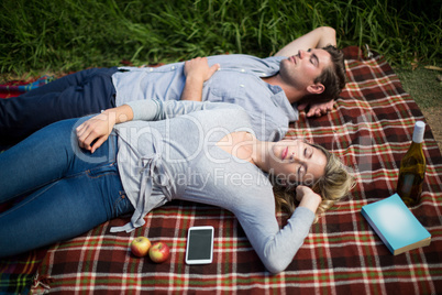 Young couple sleeping on blanket